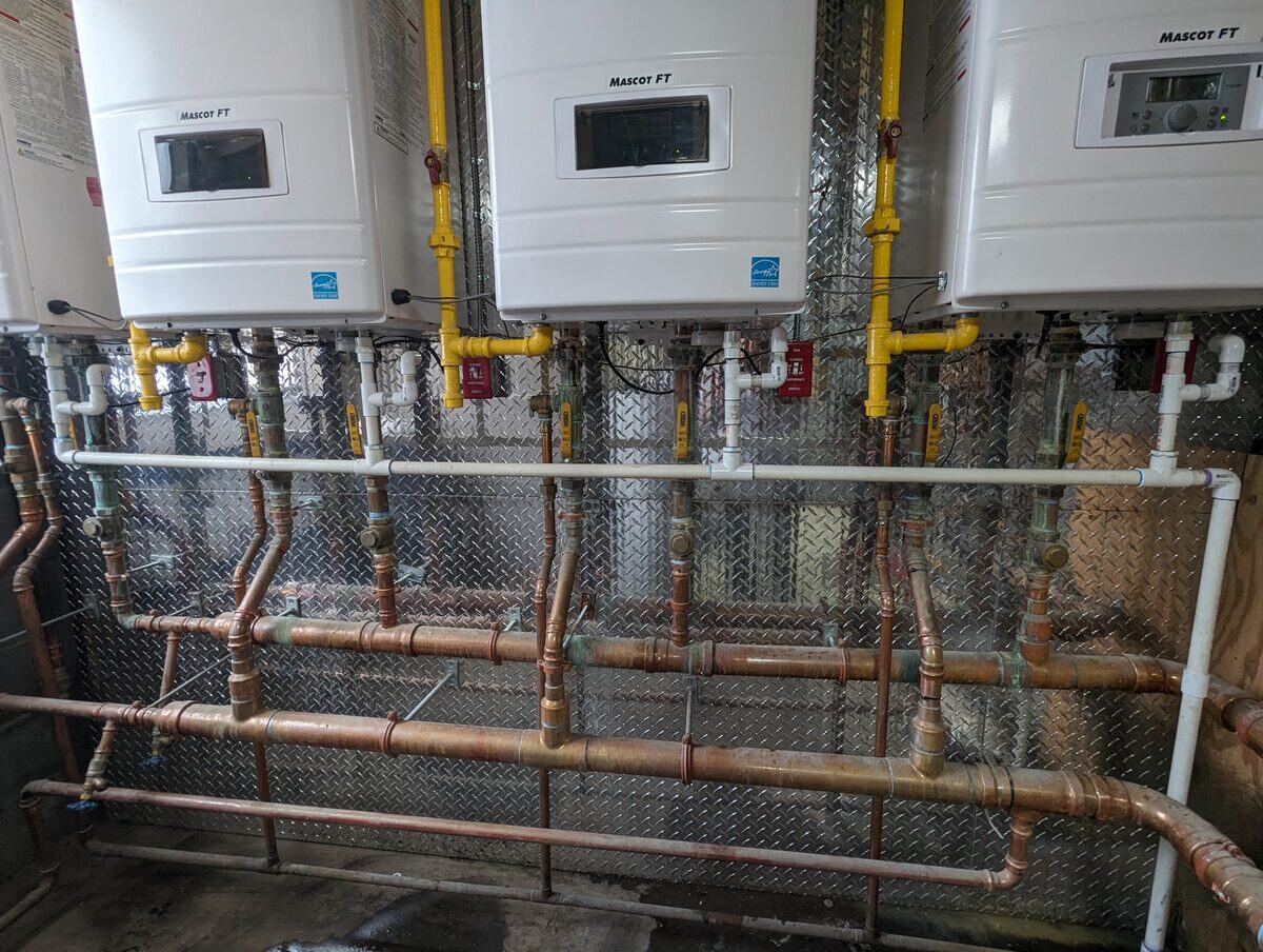 Wall-hung boiler and hydronic piping from JSEP’s installation portfolio